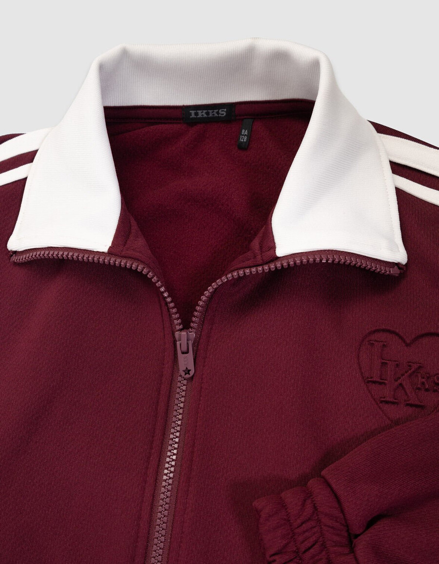 cardigan bordeaux con cerniera e fiocchi ecrù per bambine